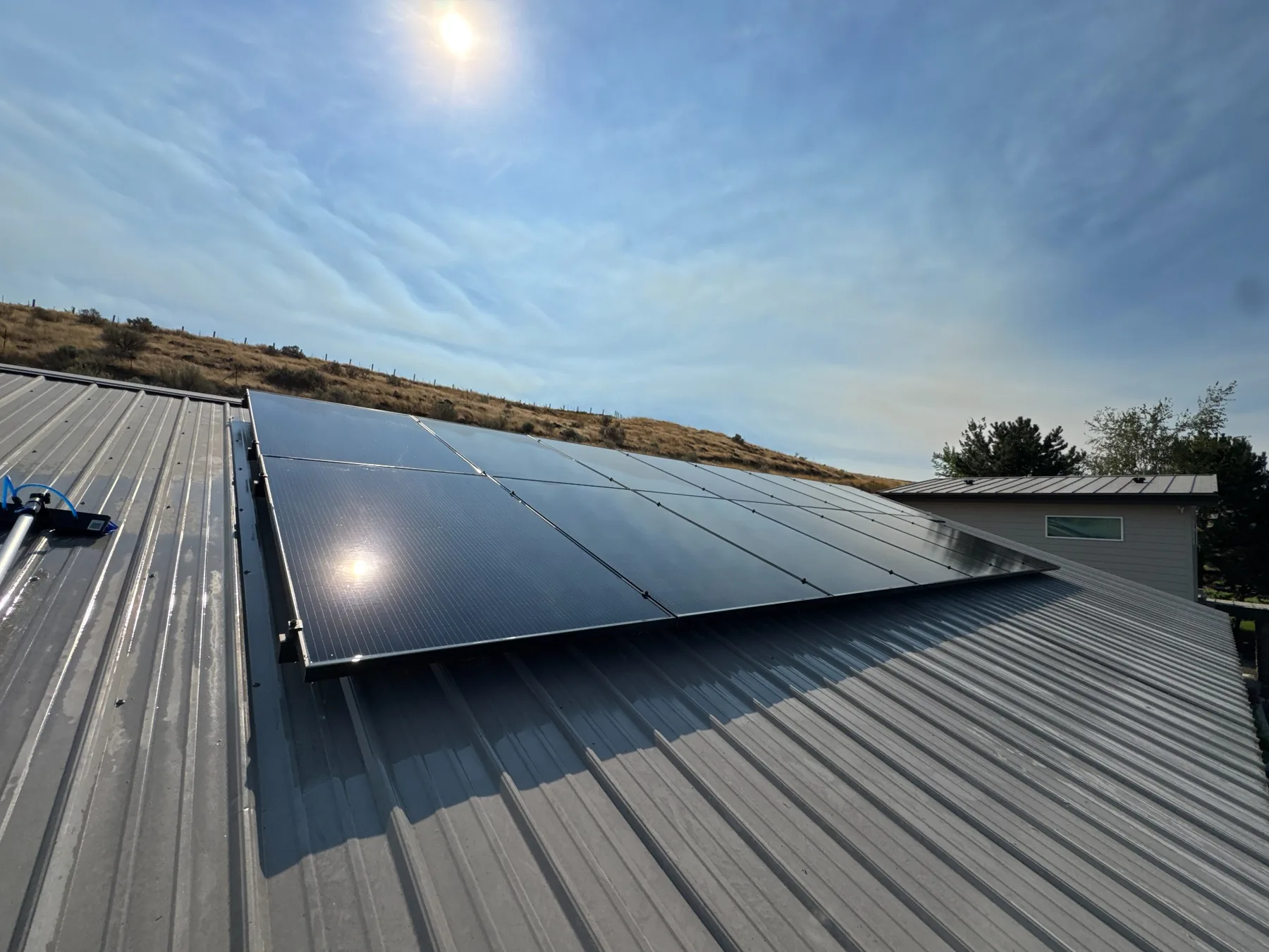 Clean residential solar panels on a metal roof in the Tri-Cities Washington