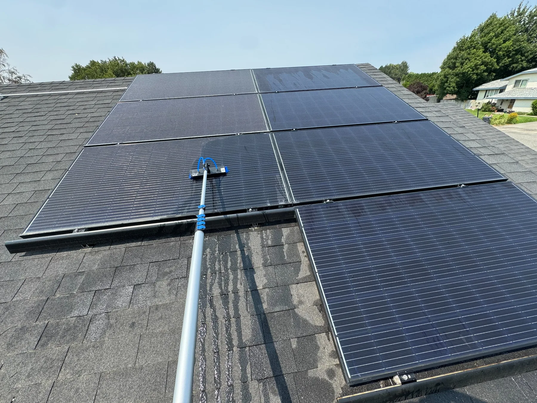 Water-fed brush cleaning residential solar panels in the Tri-Cities Washington